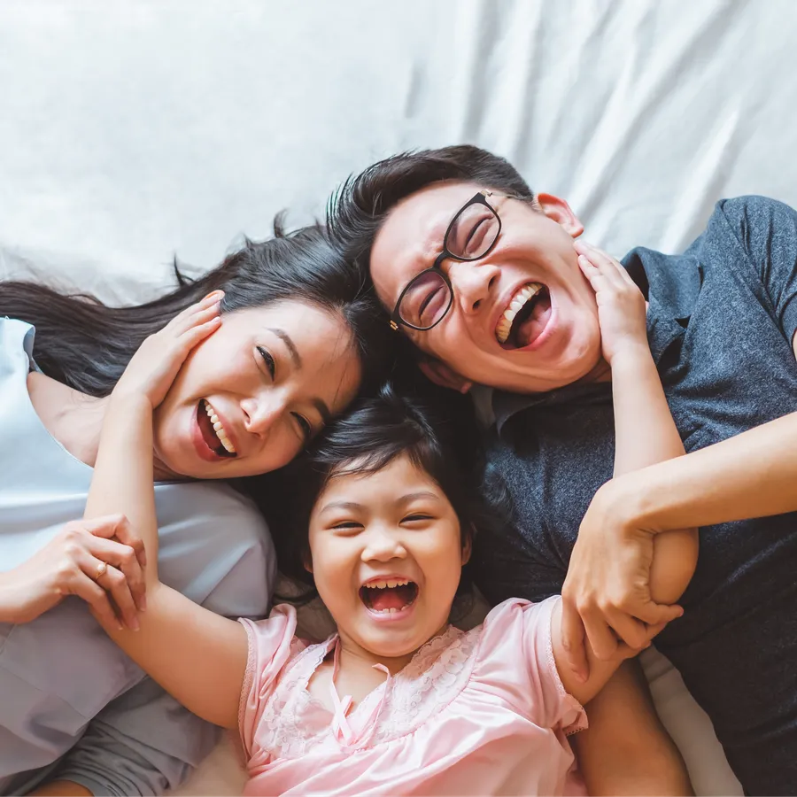 Family laughing together with healthy smiles