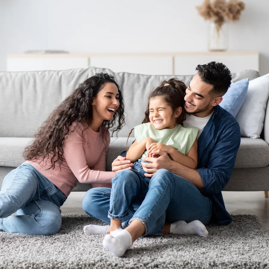 Happy family laughing together at home