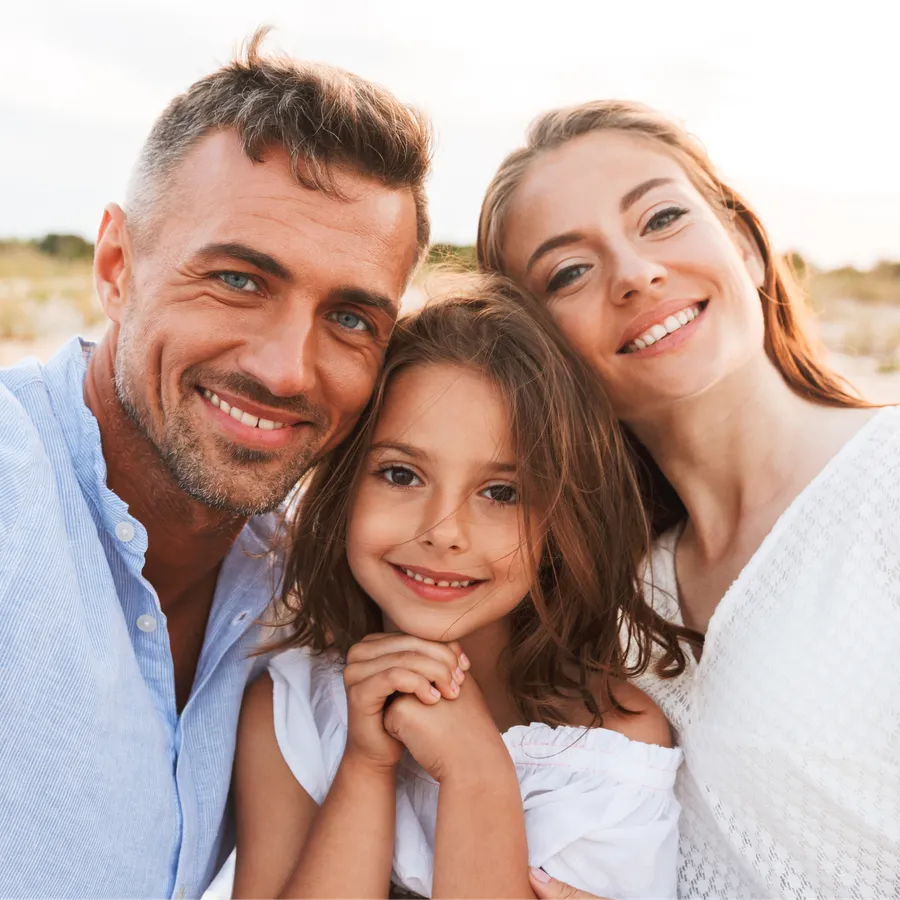 Family smiling outdoors together