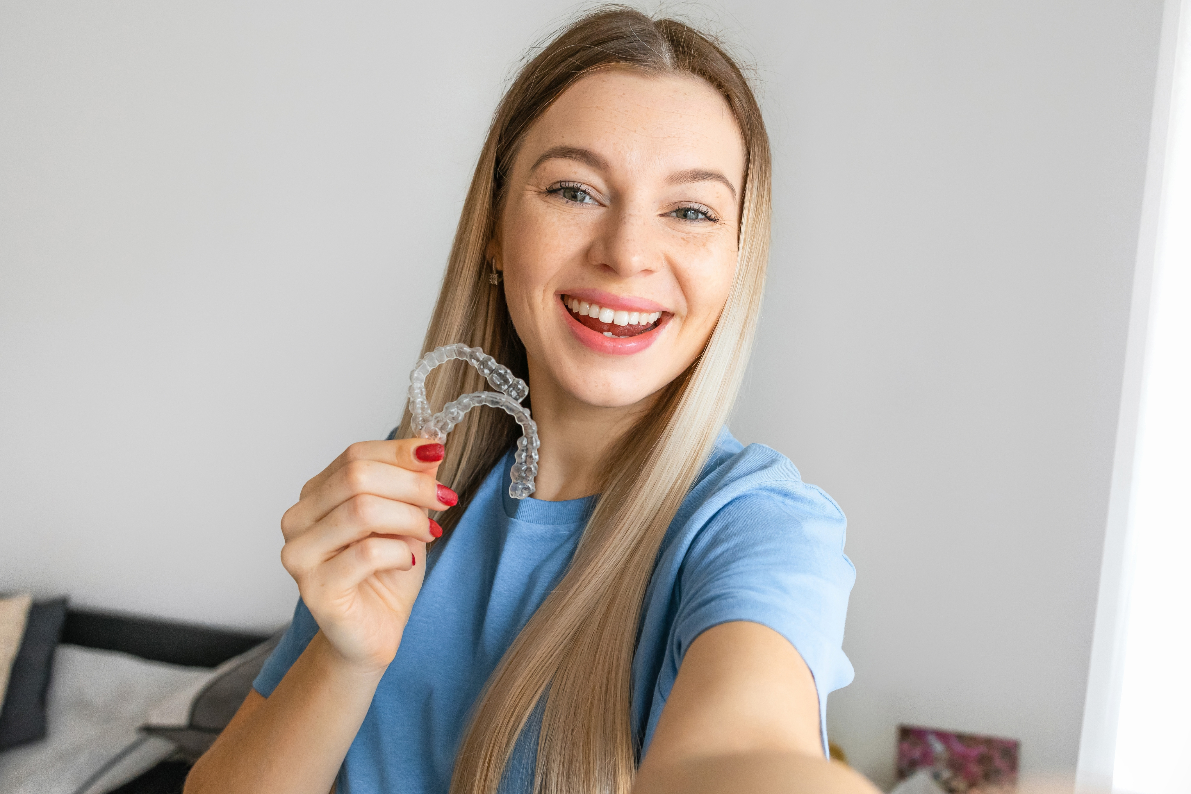 Woman smiling with Invisalign clear aligners